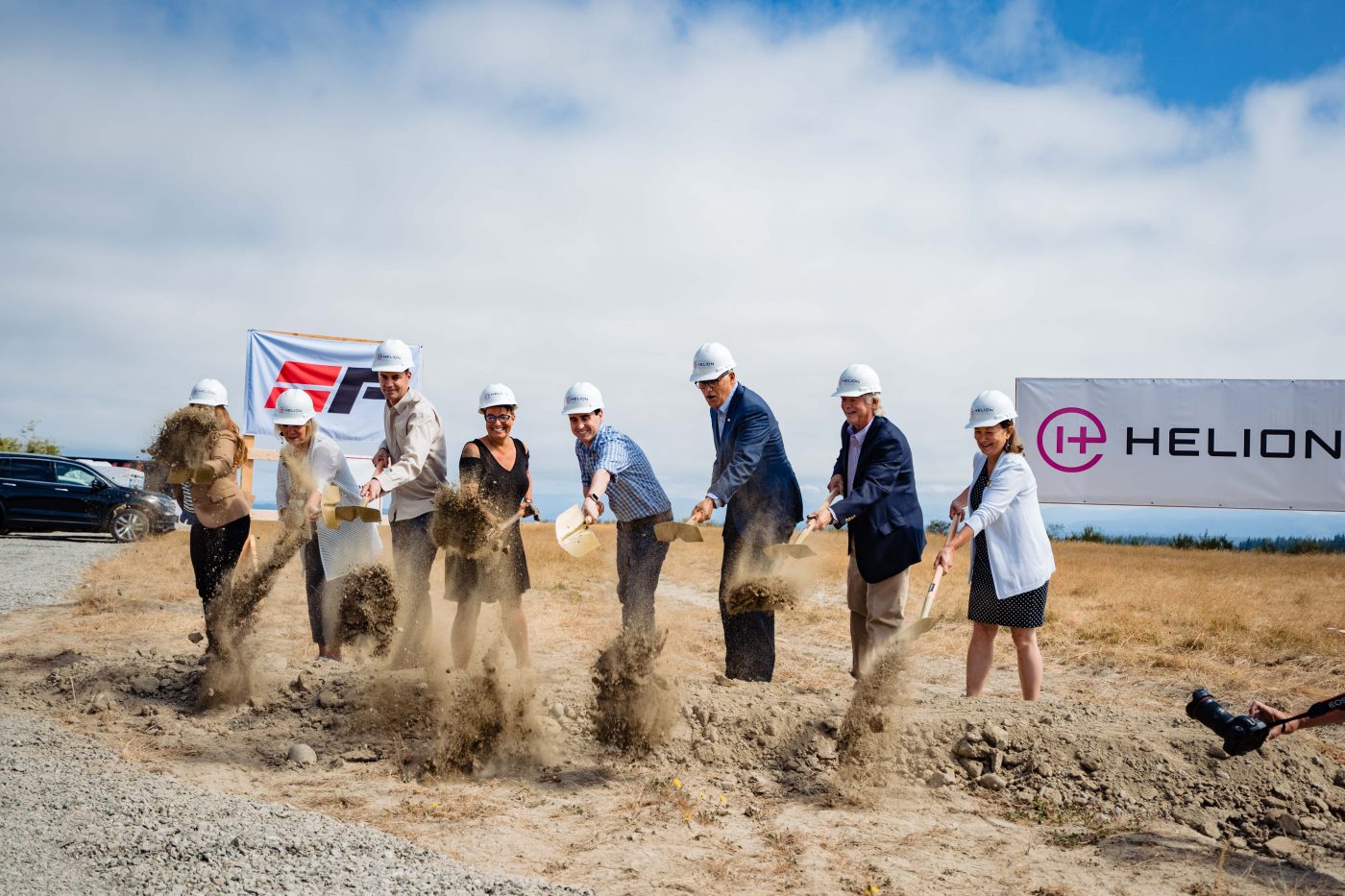 Helion and elected officials breaking ground in front of Helion sign